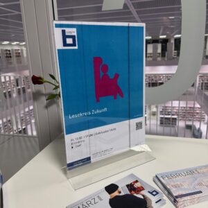 In der Stadtbibliothek Stuttgart steht auf einem Tisch ein Aufsteller zur Veranstaltung "Lesekreis Zukunft"